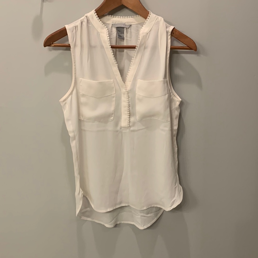 Cream tank too blouse with delicate detail around chest. Size 2